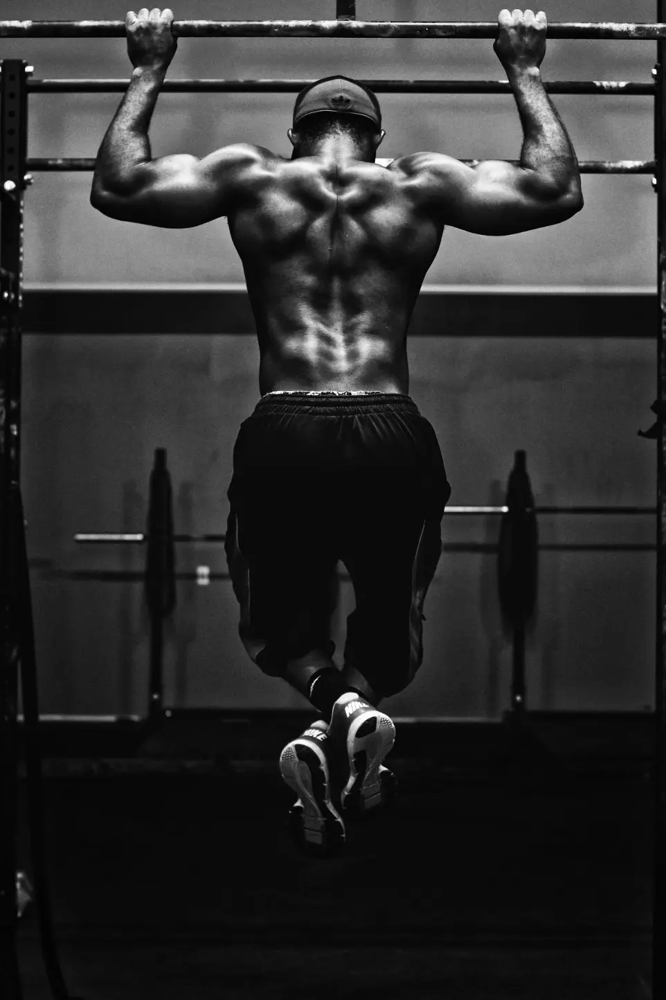 grayscale photo of man working out